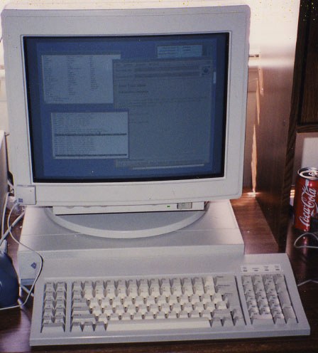 A Sun SPARCstation 1 pizzabox workstation with a CRT monitor and keyboard on a desk, photographed in the early 1990s.