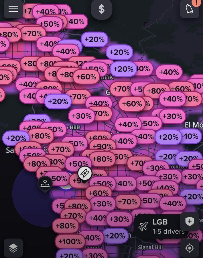 A rideshare driver app showing a city map covered edge to edge in surge multipliers from plus 10 percent to plus 100 percent.